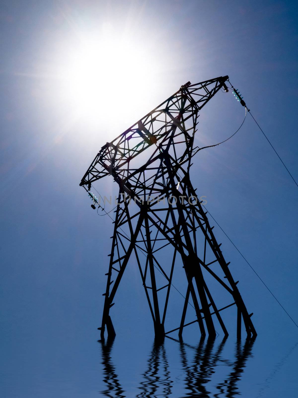 Electricity transformer and sun with water reflection