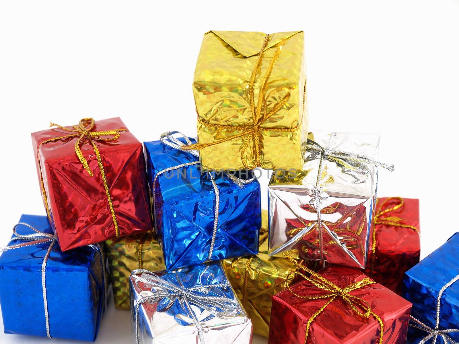 Colorful gift boxes in shiny wrapping paper isolated against a white background.