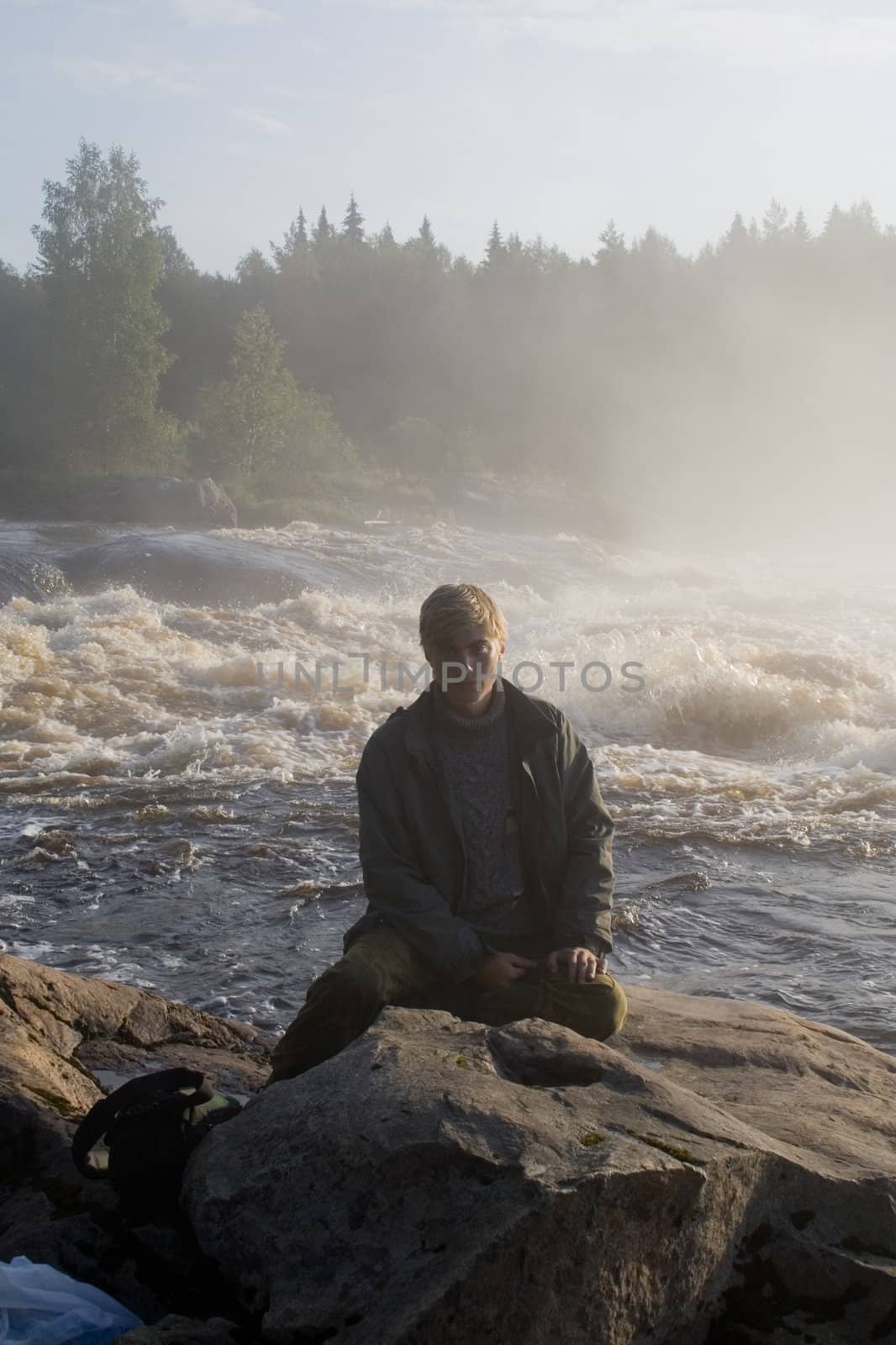 Portrait of young man near rapid.
