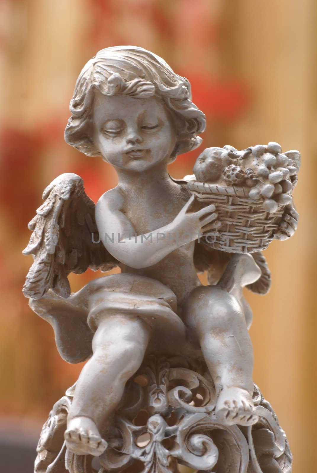 Angel statue with fruit basket.