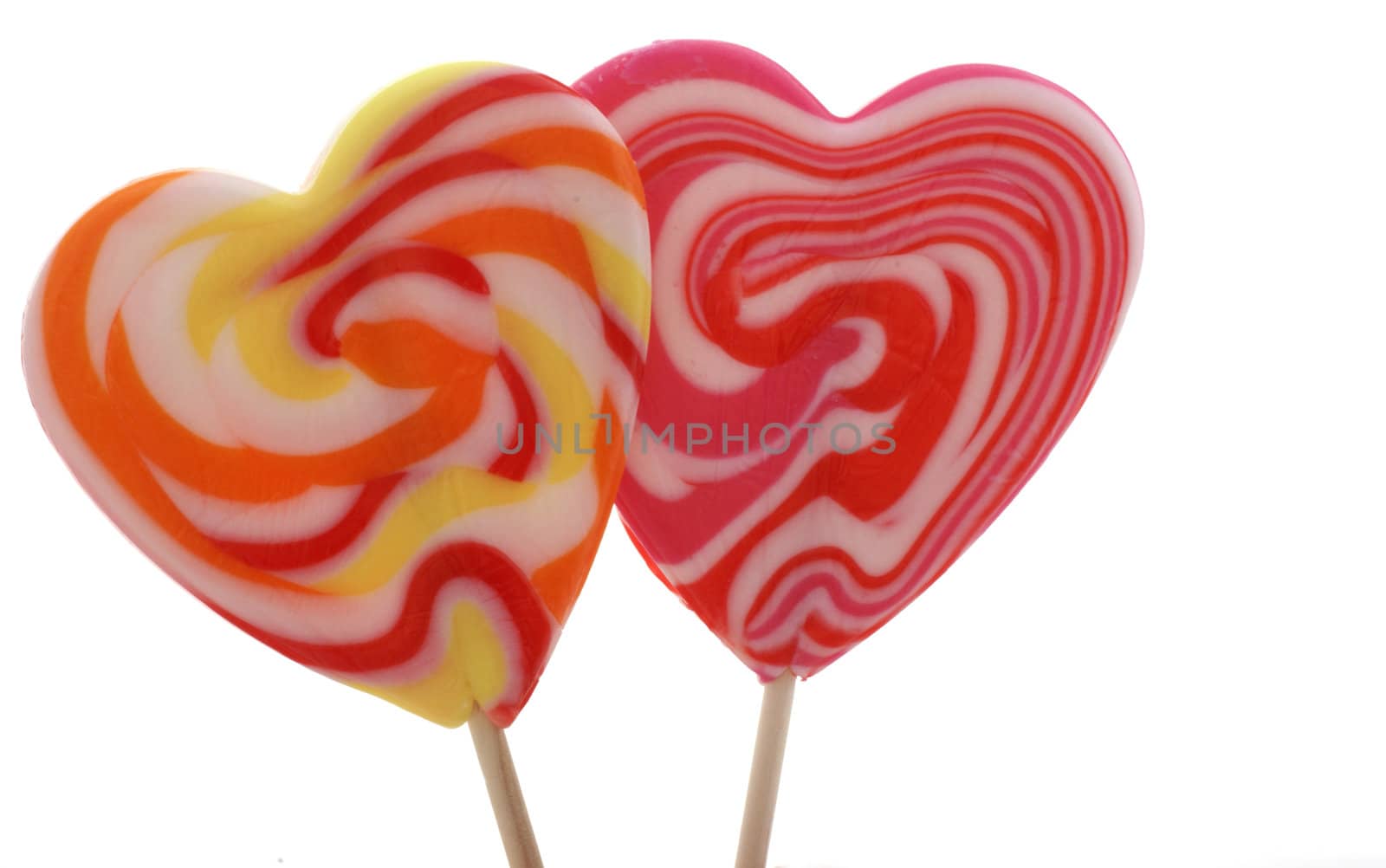 Two isolated heart shaped lollypops.