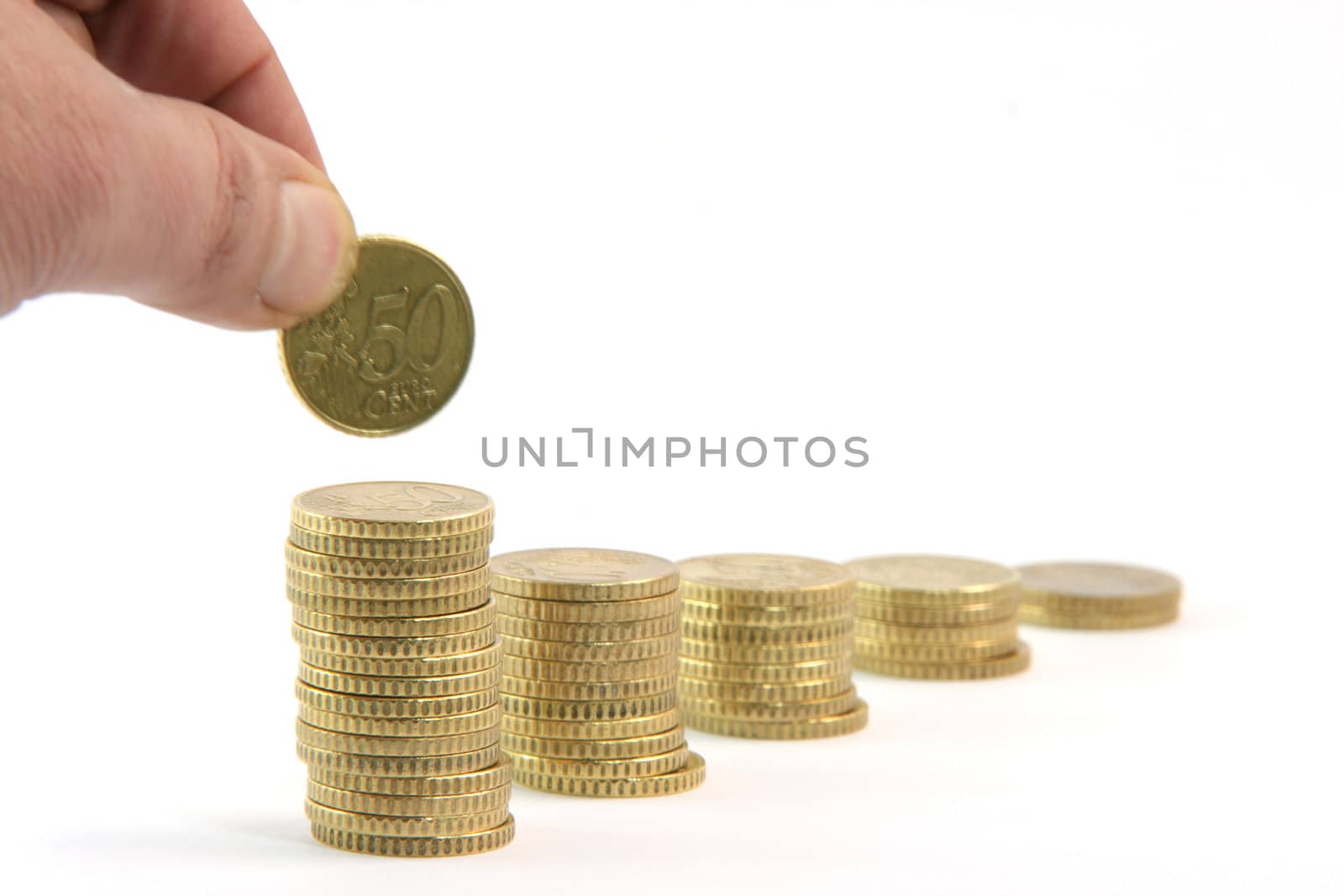 adding a coin to stacks of fifty euro cents in a row isolated on white background business and finance concepts