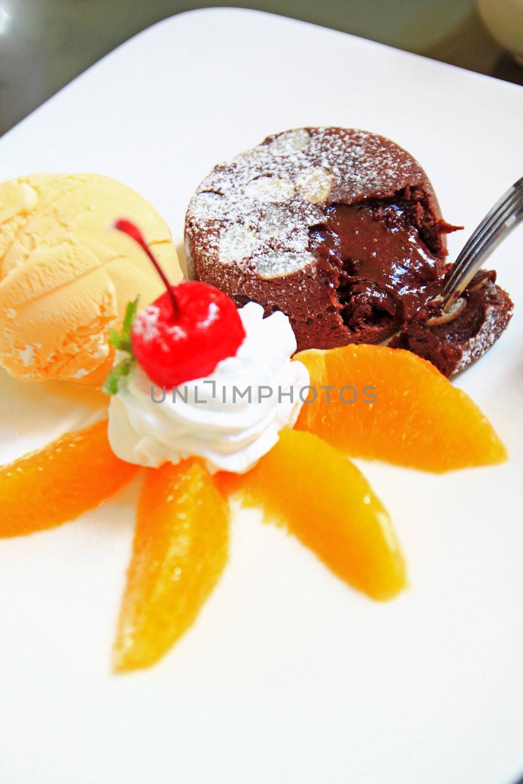 hot chocolate cake with ice cream and orange