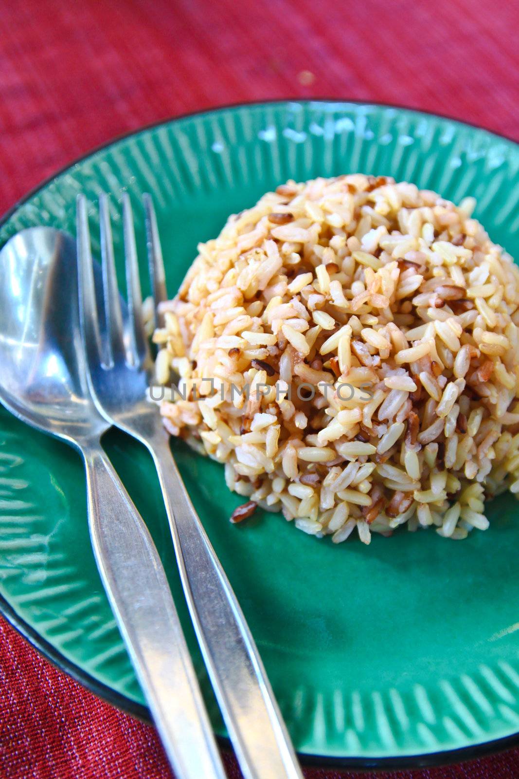 Plate of brown cooked rice from thailand