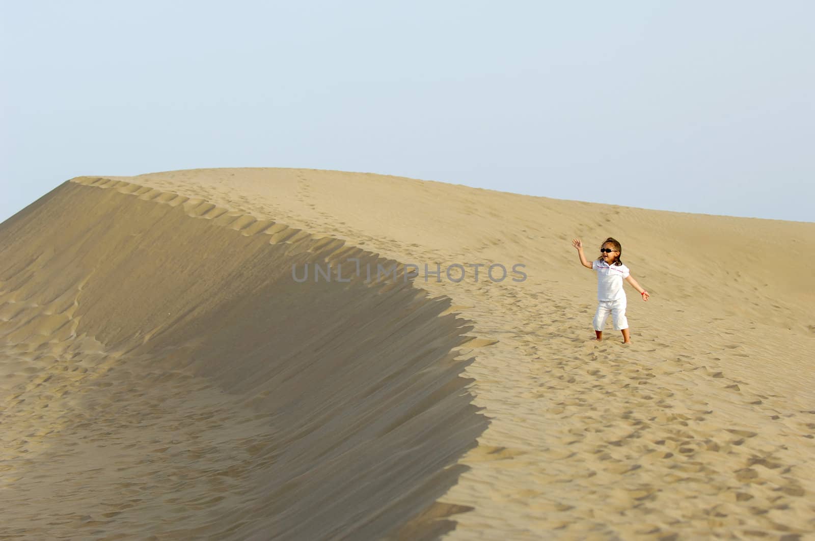 A very happy child in the desert