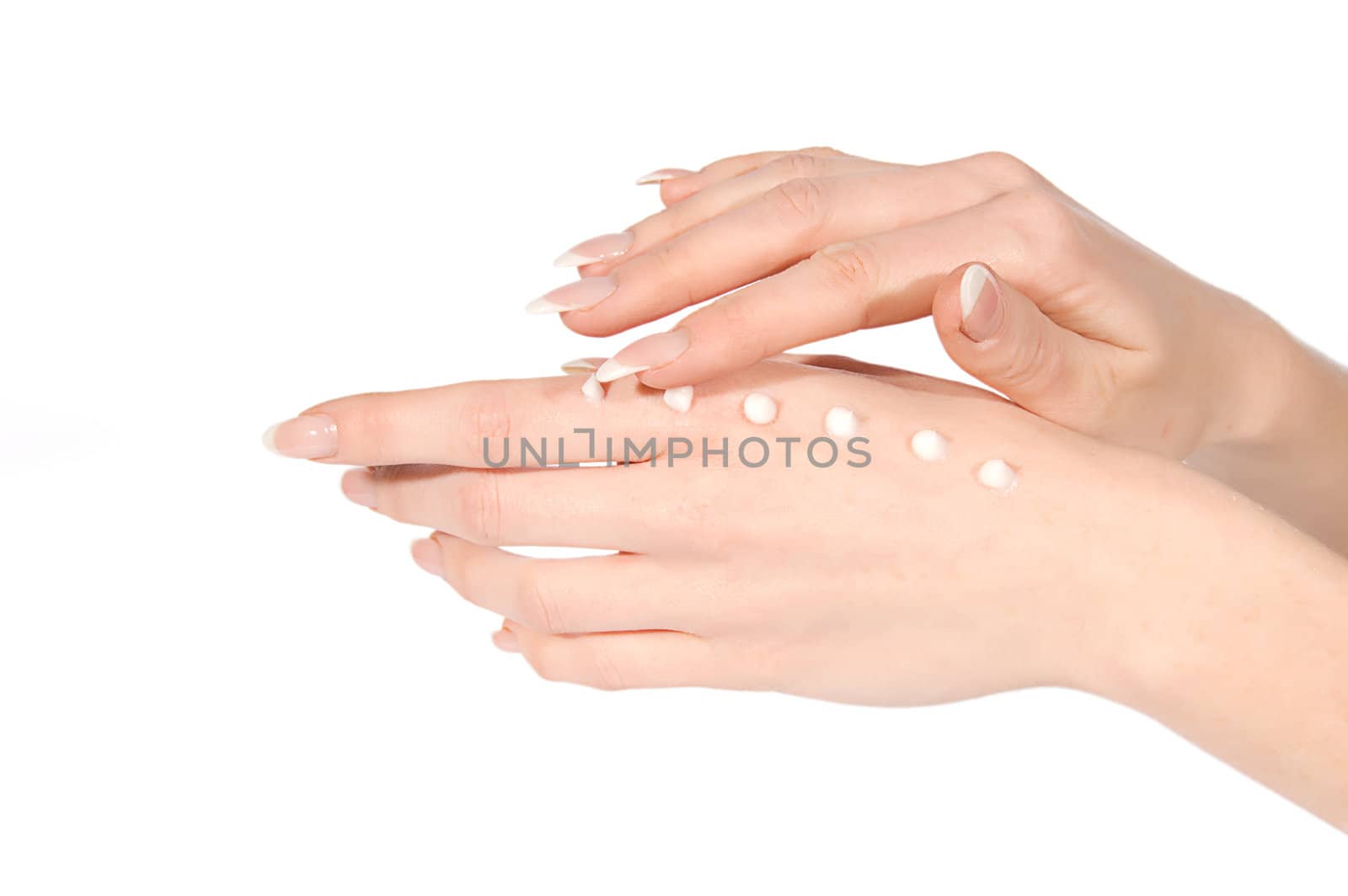 Woman hands applying cream over white