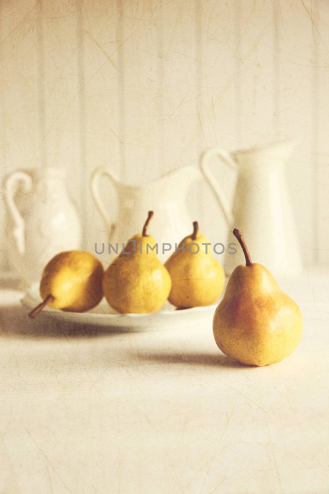 Fresh pears on old wooden table by Sandralise