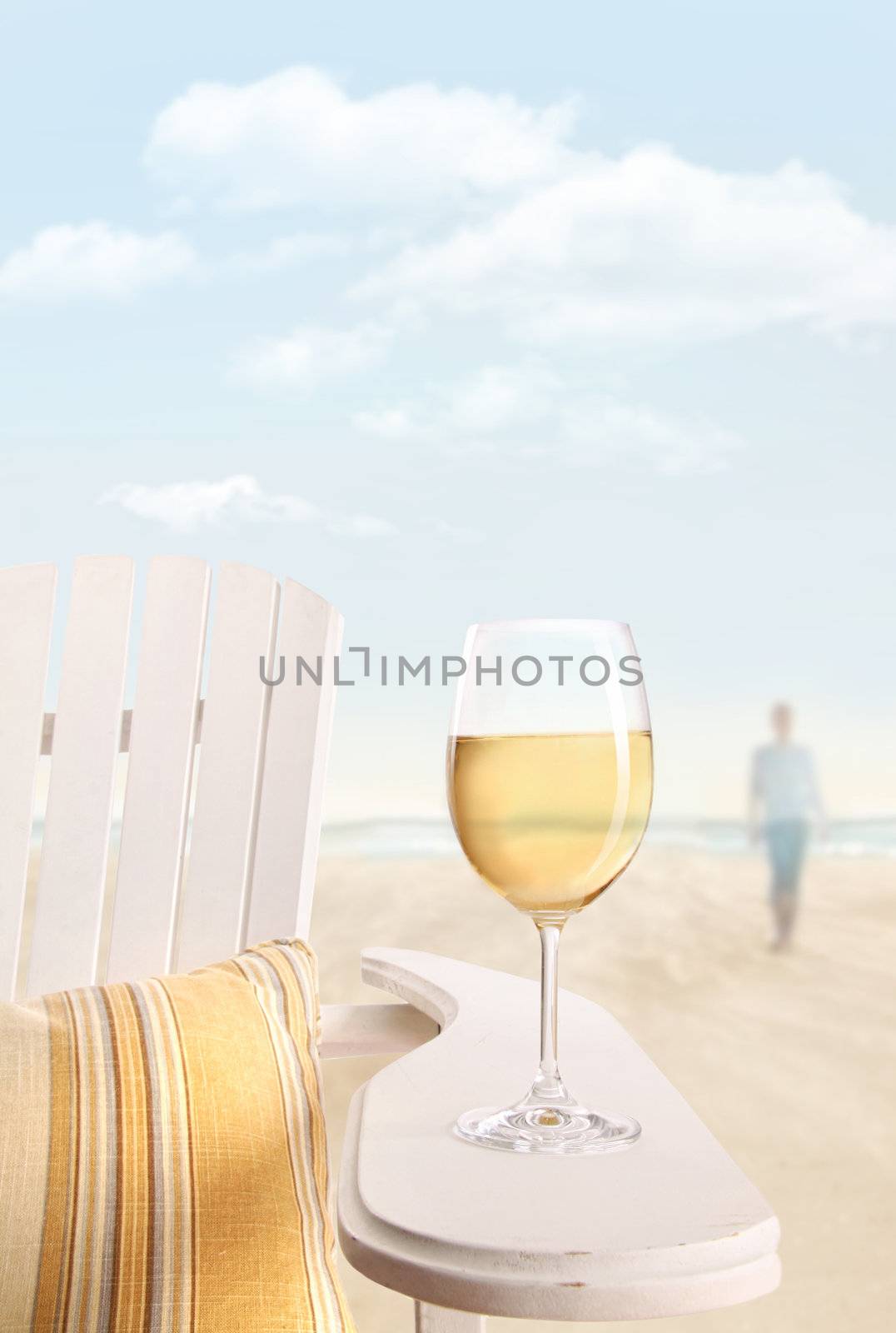 Glass of white wine on adirondack chair by Sandralise
