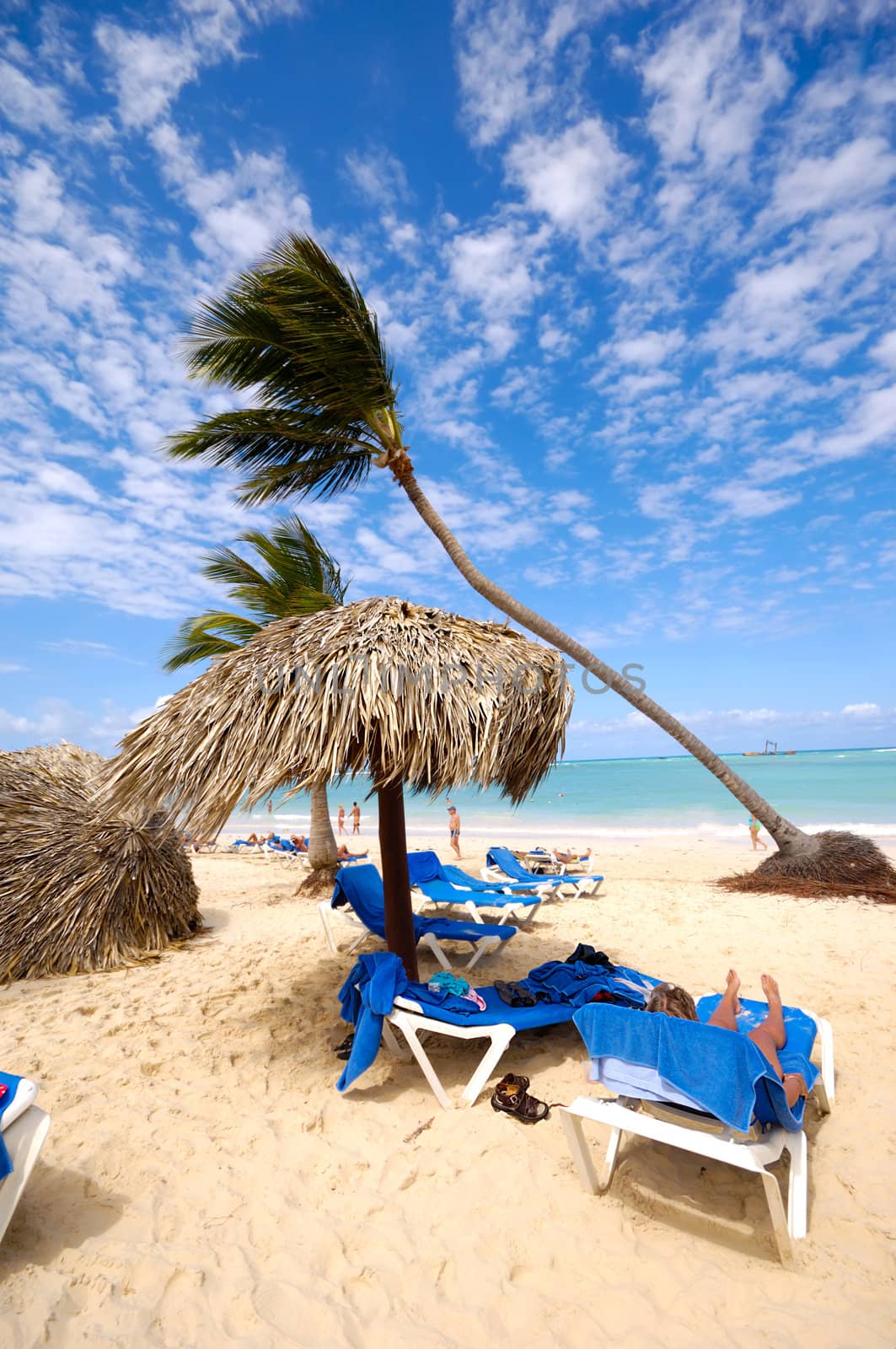 Sunbeds and parasol on an exotic beach. Dominican Republic, Punta Cana.