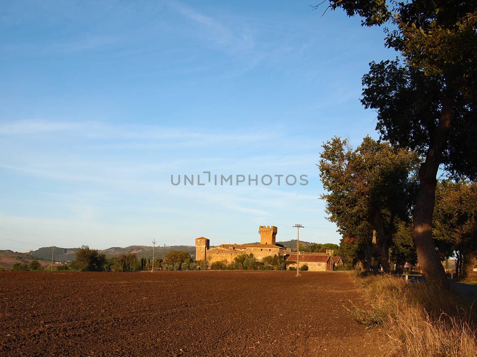 Barren landscape in Tuscany with a castle.