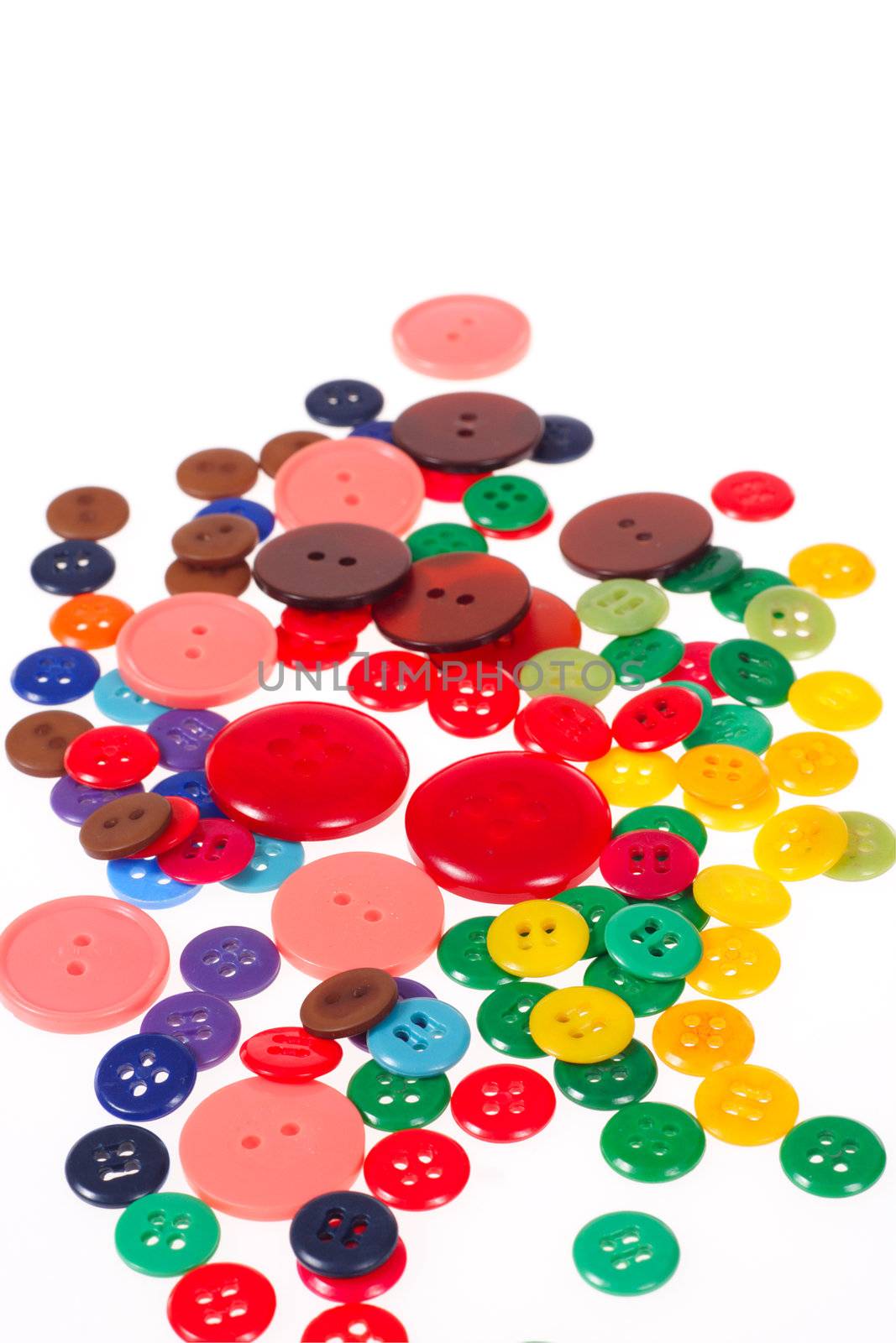 Many different sized and shaped buttons photo on white background