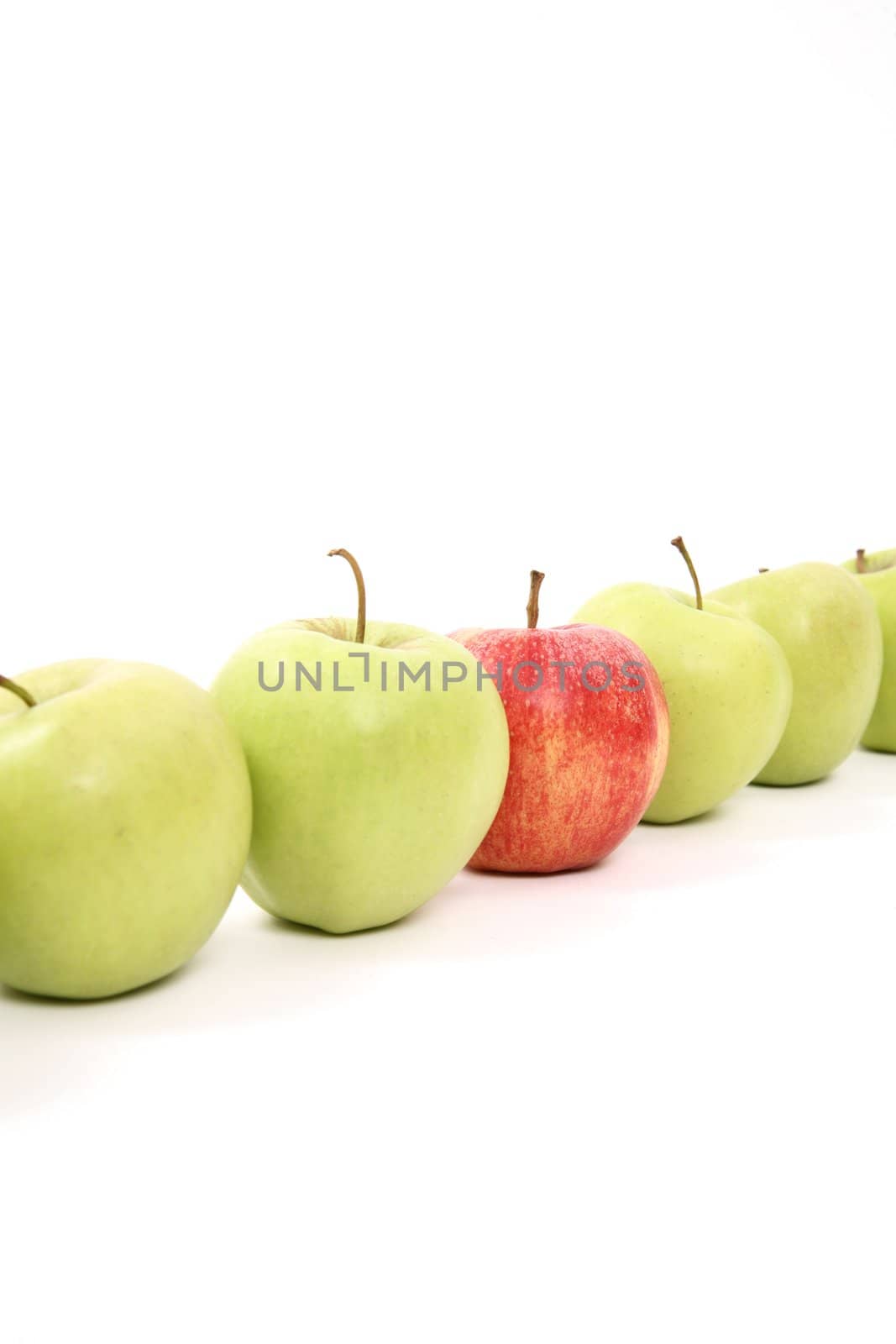 apples arranged on a white background to symbolize teamwork, leadership, discrimination............