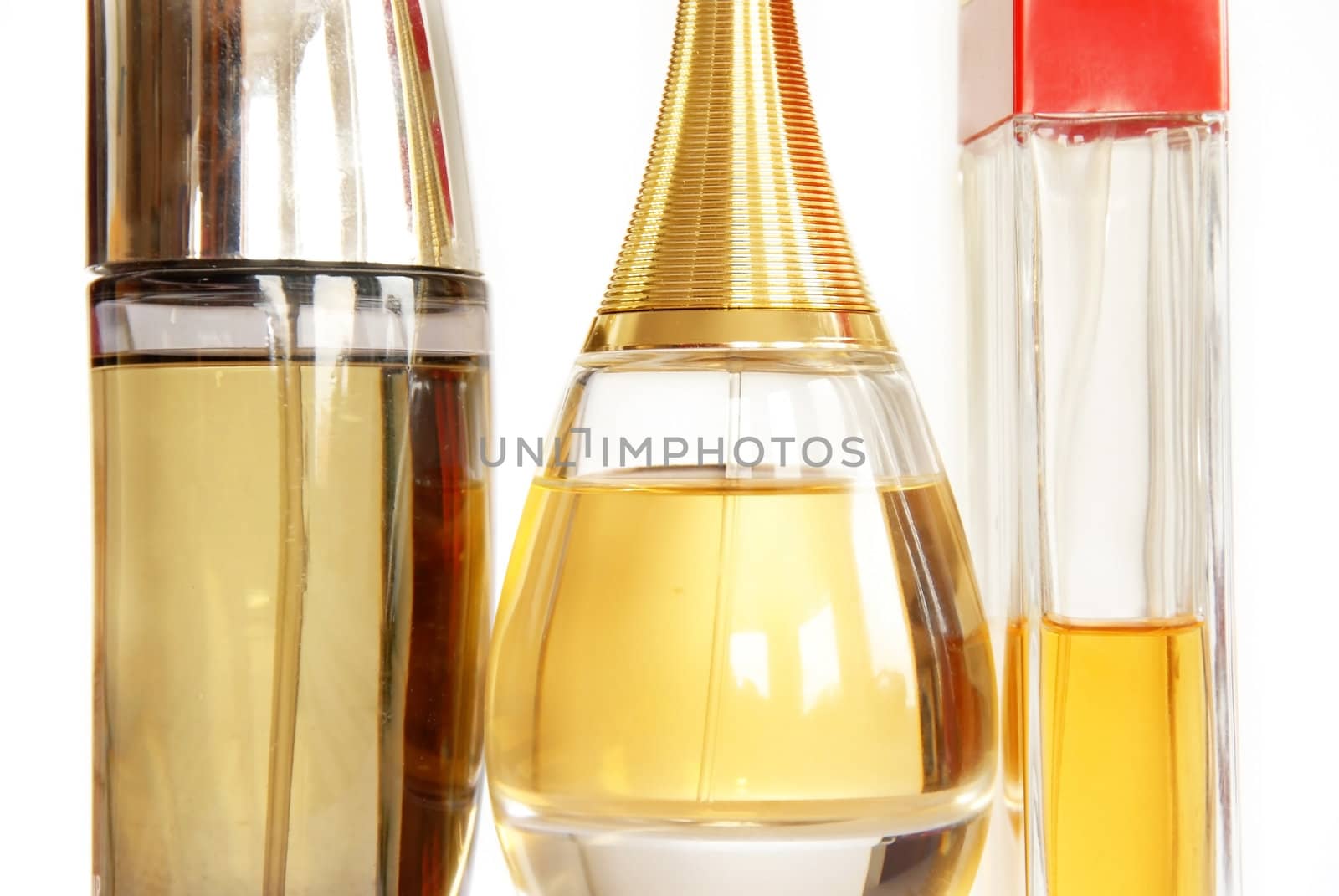 group of several perfumes in glass bottles over white background