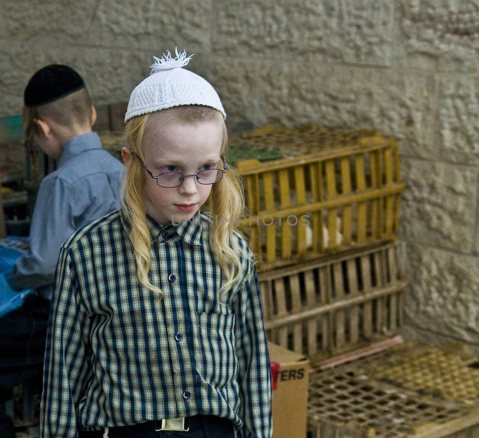 JERUSALEM - OCT 06 : An ultra Orthodox Jewish boy near a cages with chickens use for the "Kaparot" ceremony held in Jerusalem Israel in October 06 2011 