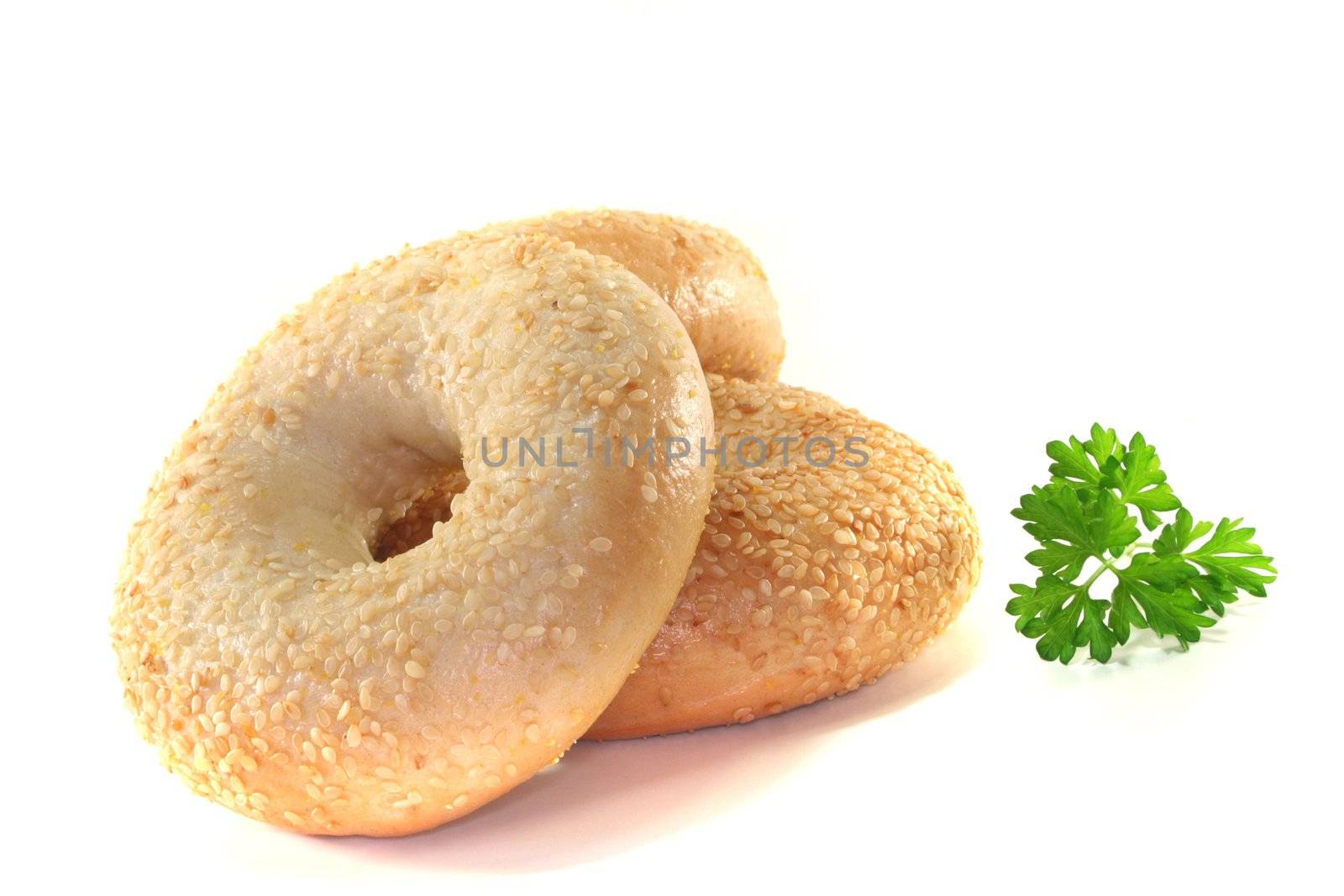 three bagel with parsley on a white background