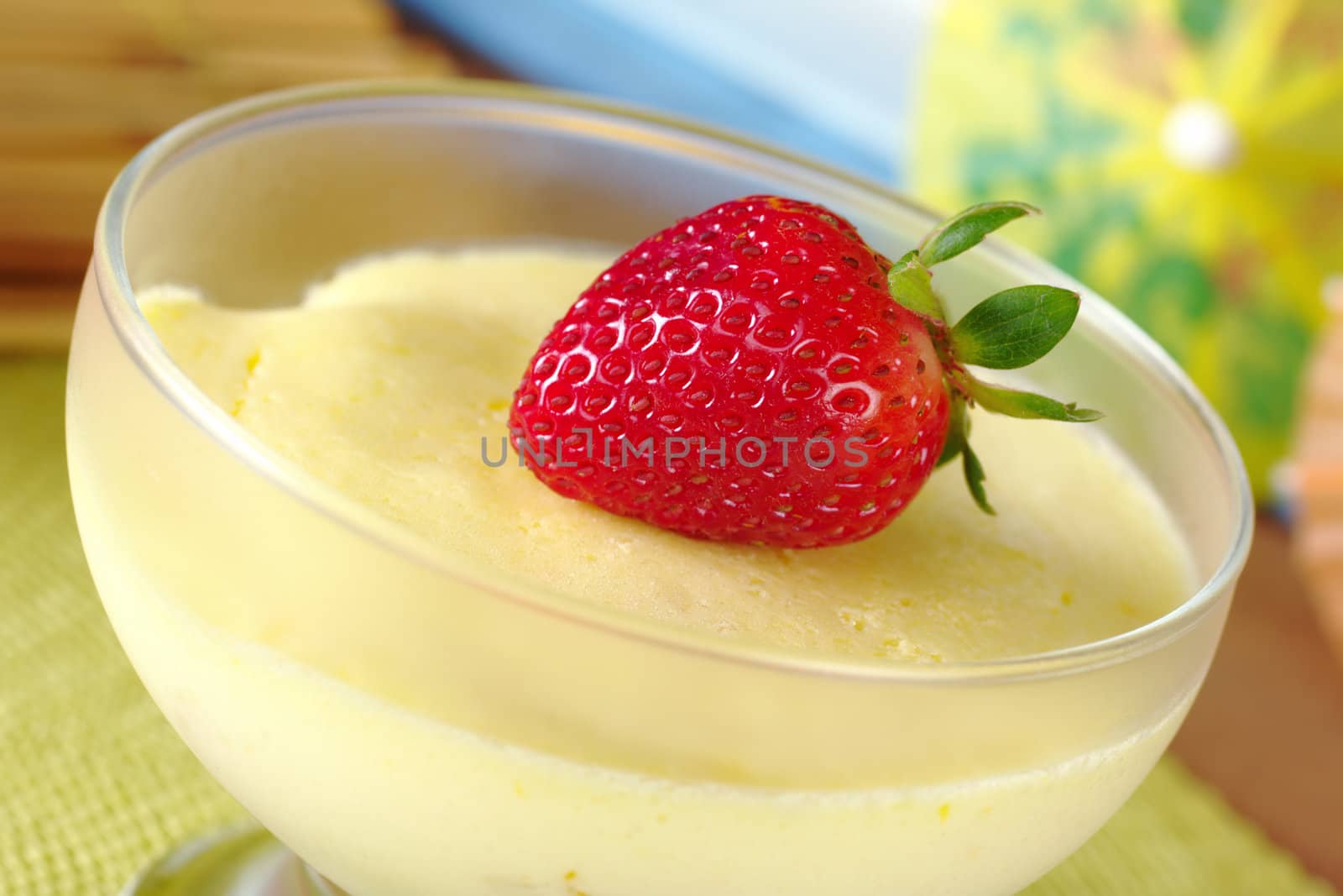 Fresh strawberry on cream cheese dessert in a glass bowl (Selective Focus, Focus on the front of the strawberry)