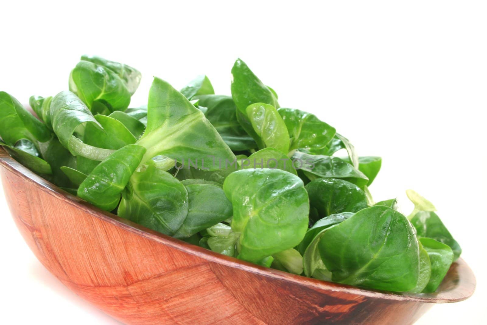 fresh corn salad in a wooden bowl on white background