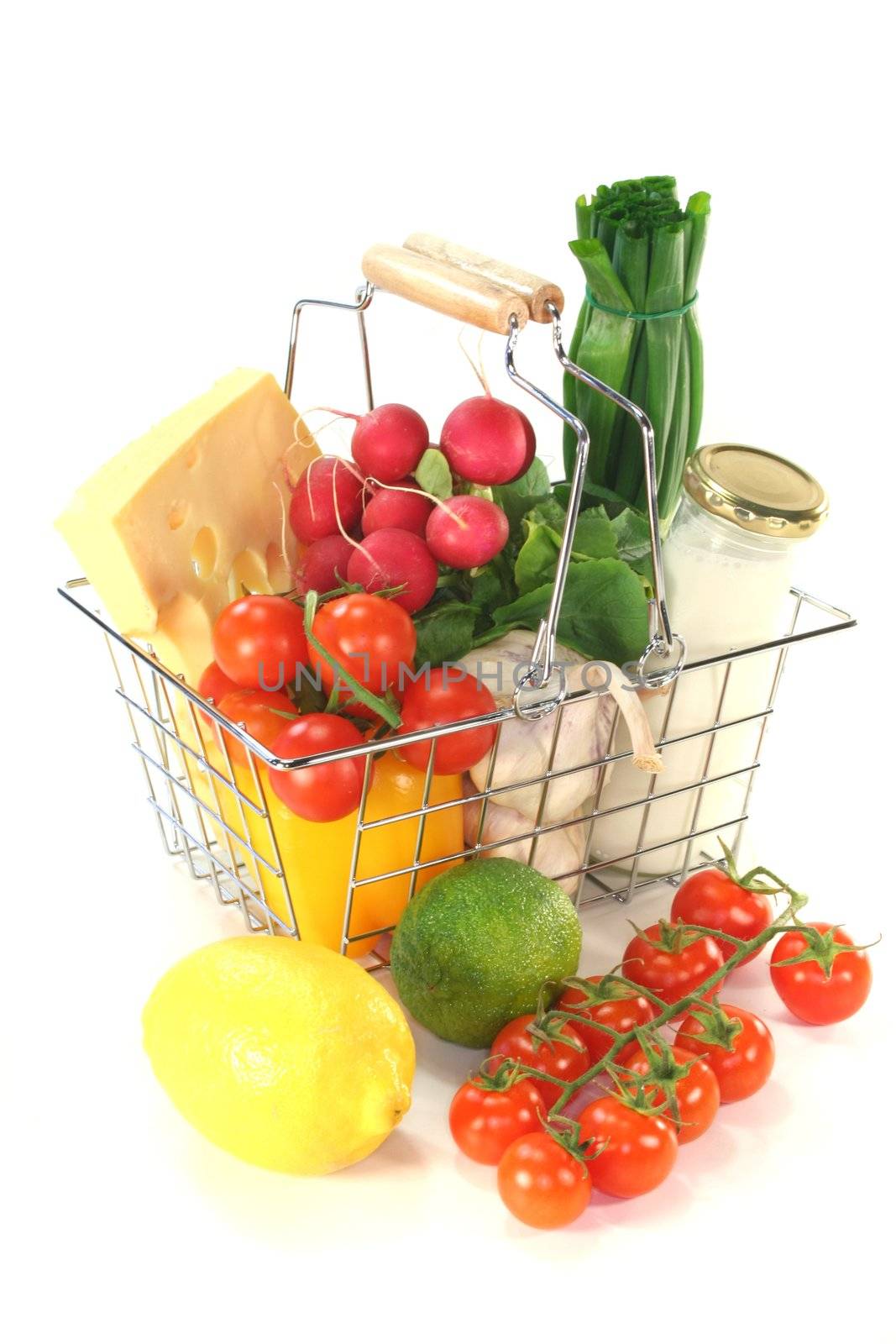 Shopping cart with milk, cheese and mixed vegetables