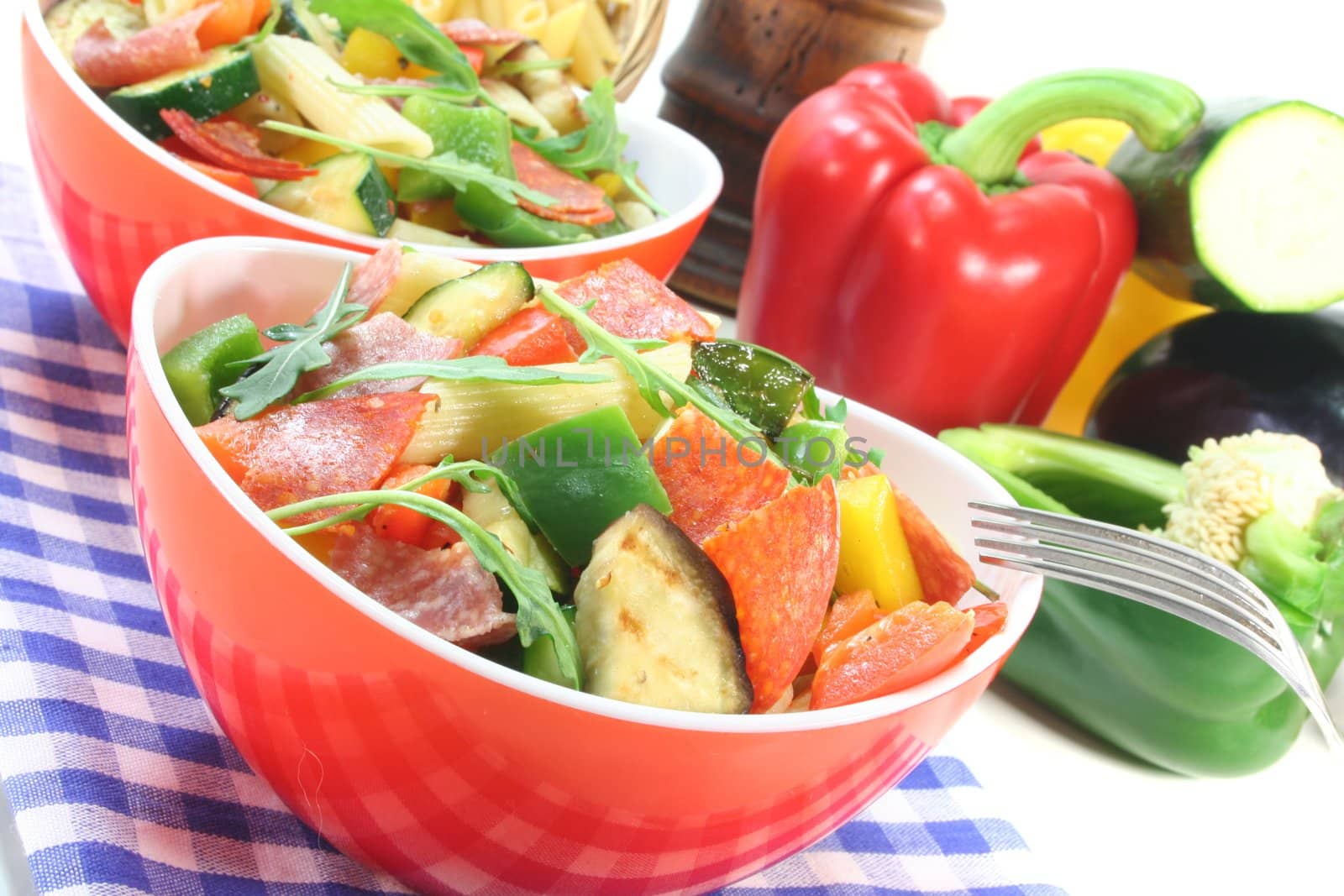 Penne salad with eggplant, zucchini, peppers, olives and rocket