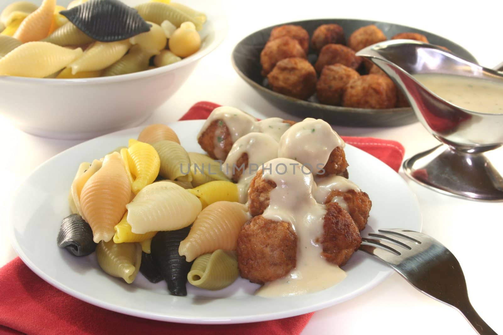 Koettbullar with Conchiglie and herb cream sauce on a plate