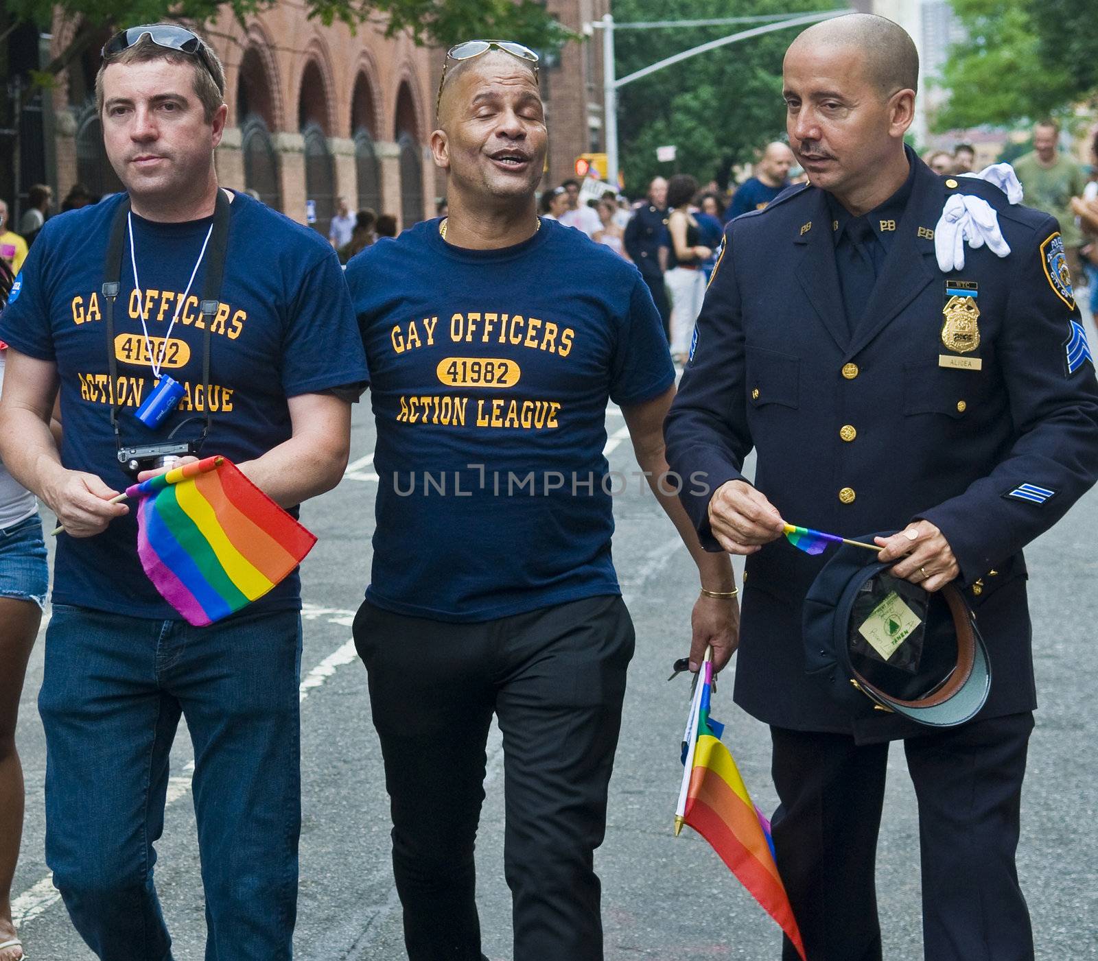 NEW YORK -  JUNE 26 : An unidentified three gay police officers celebrates gay pride parade after passing the same sex marrige bill in New York city on June 26 2011.