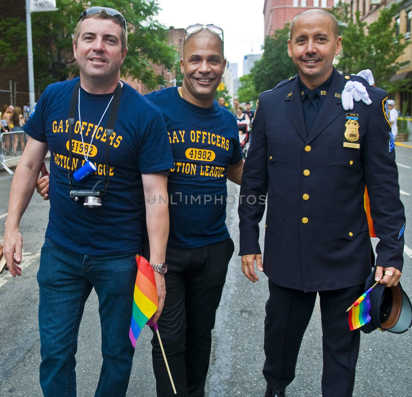 NEW YORK -  JUNE 26 : An unidentified three gay police officers celebrates gay pride parade after passing the same sex marrige bill in New York city on June 26 2011.