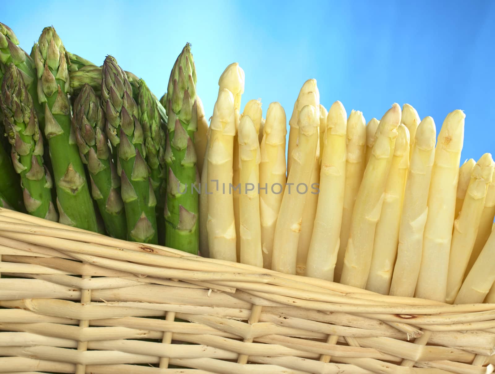 Green and white asparagus in basket 