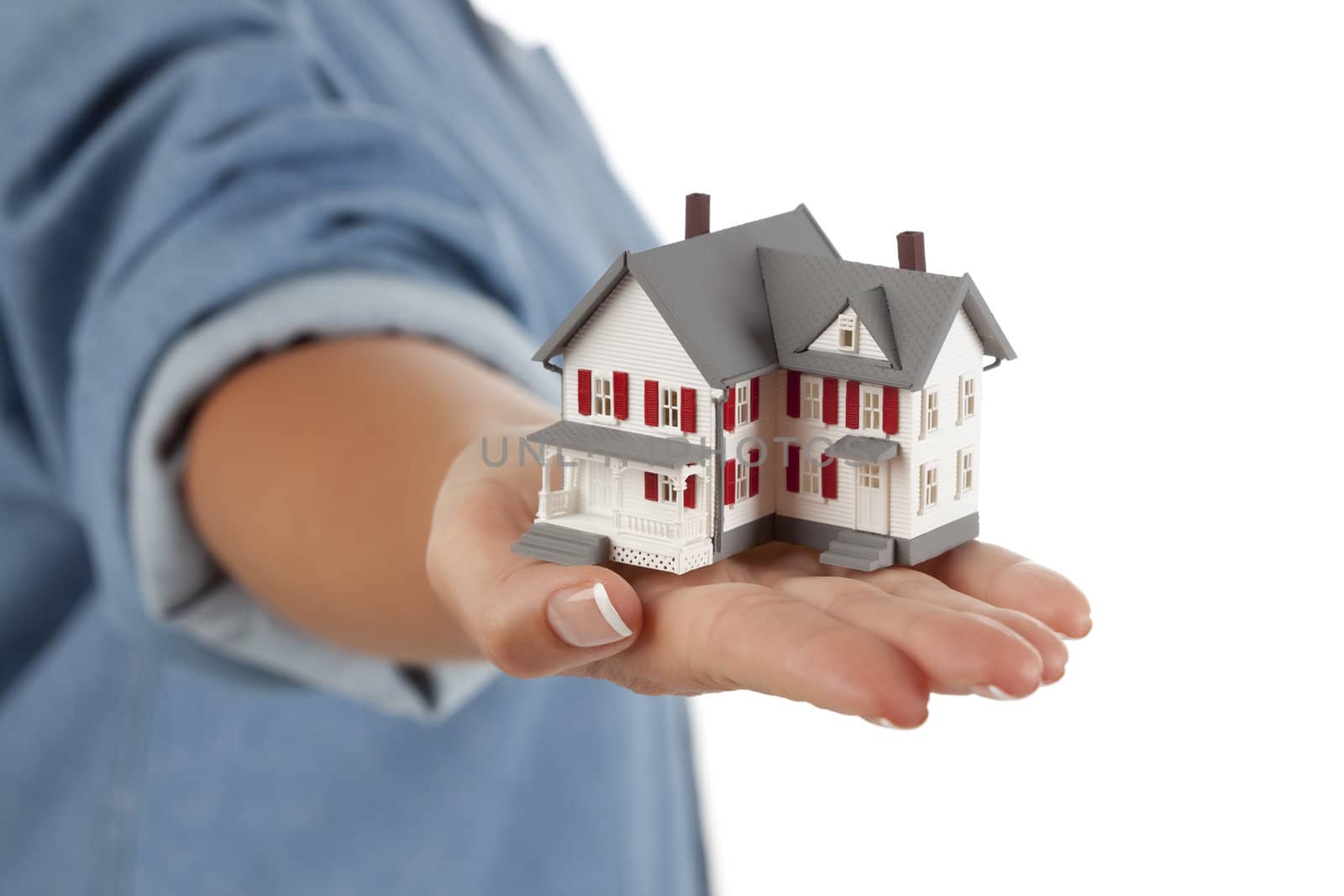 Model House in Female Hand Isolated on One Side with a White Background.
