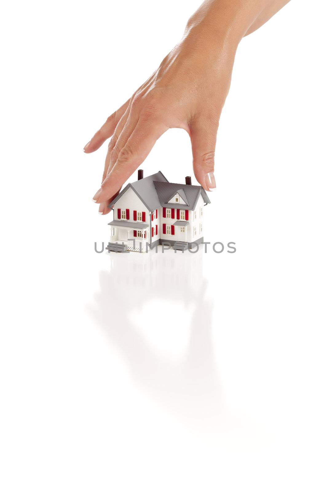 Womans Hand Choosing A Home on a White Background.