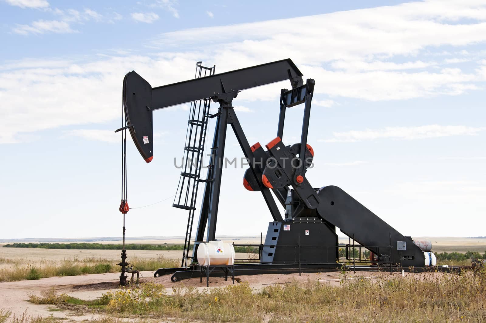 Pump jack starting the lifting stroke to brink crude oil up out of a producing oil well.