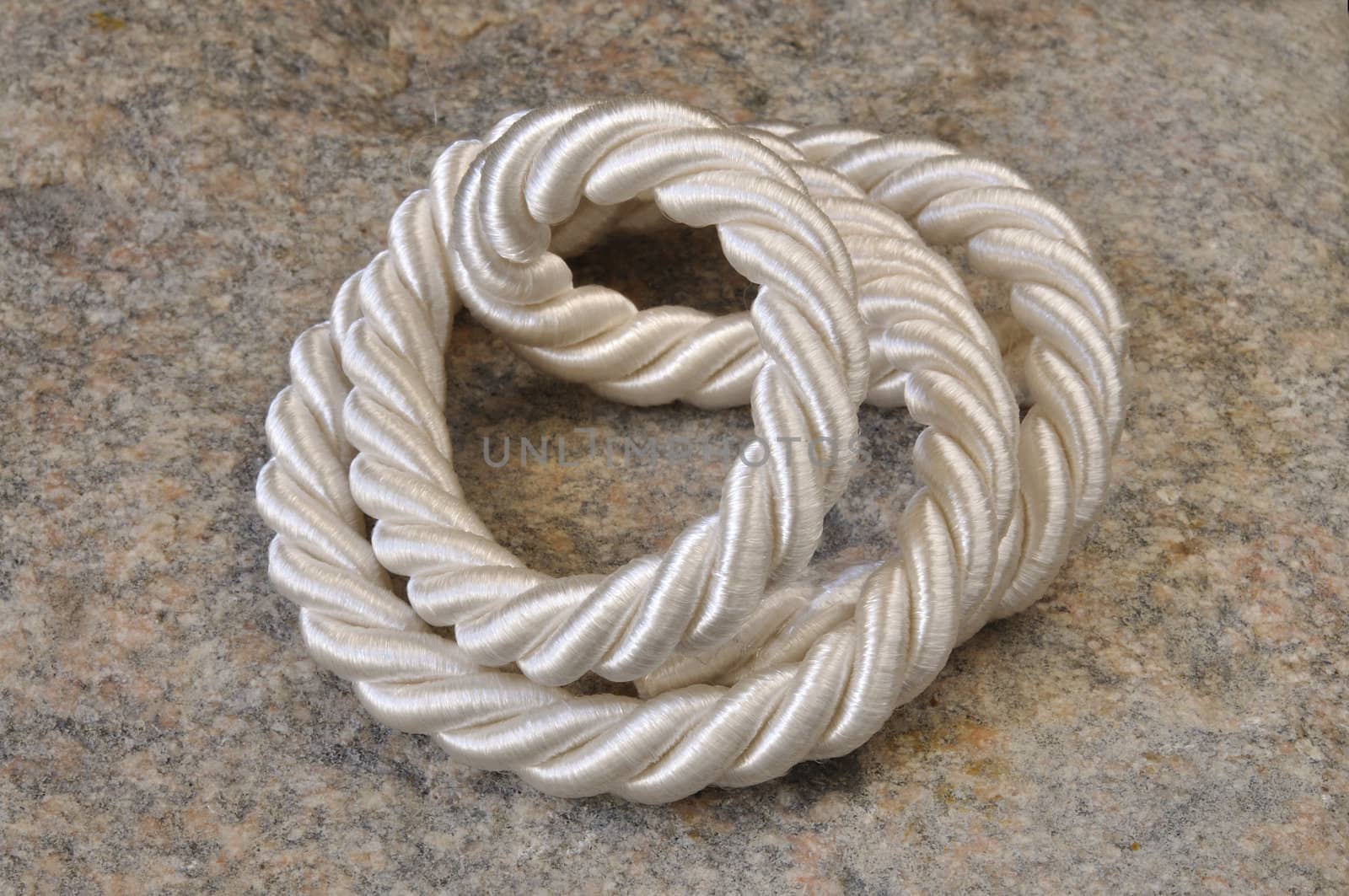 Background from a gray stone and a wattled rope
