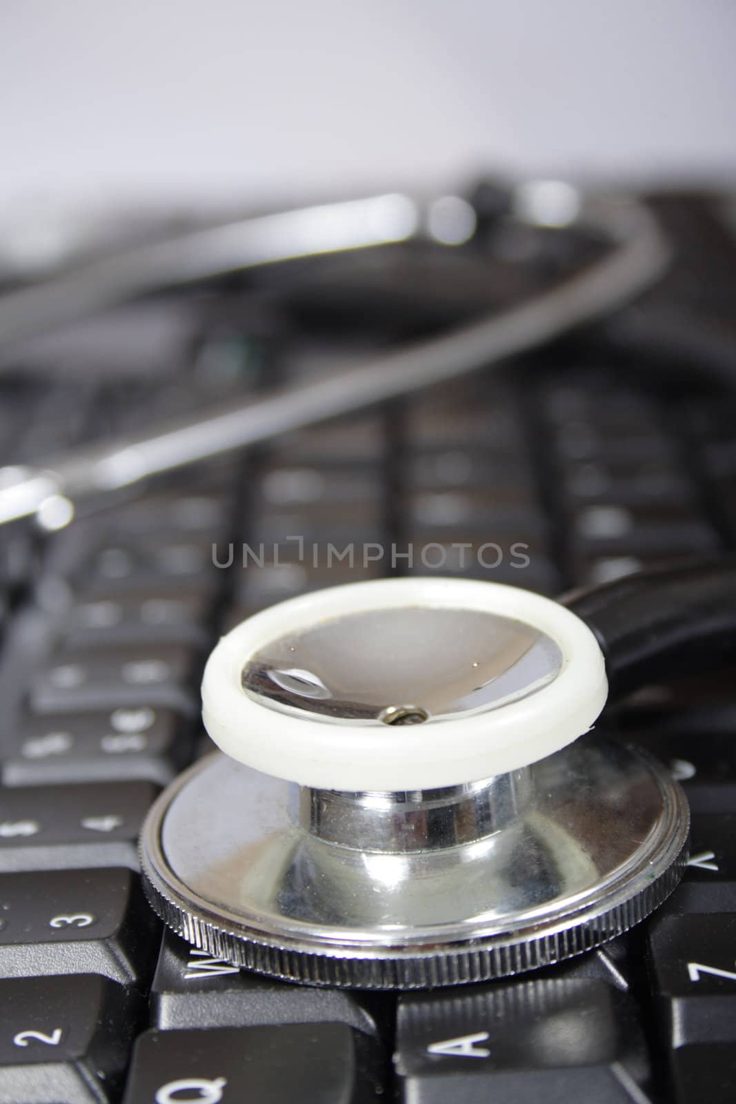 stethoscope on black keyboard of the computer