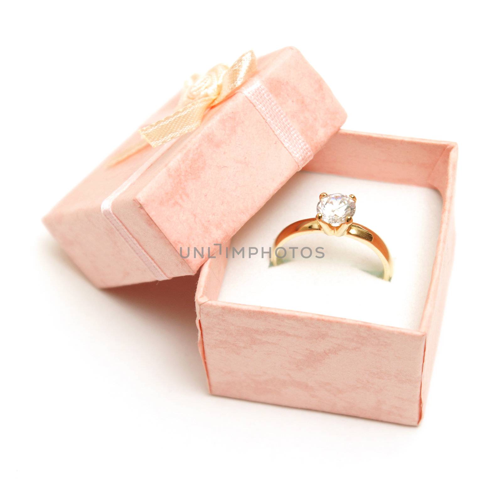 A beautiful diamond ring in a pink jewelry box.