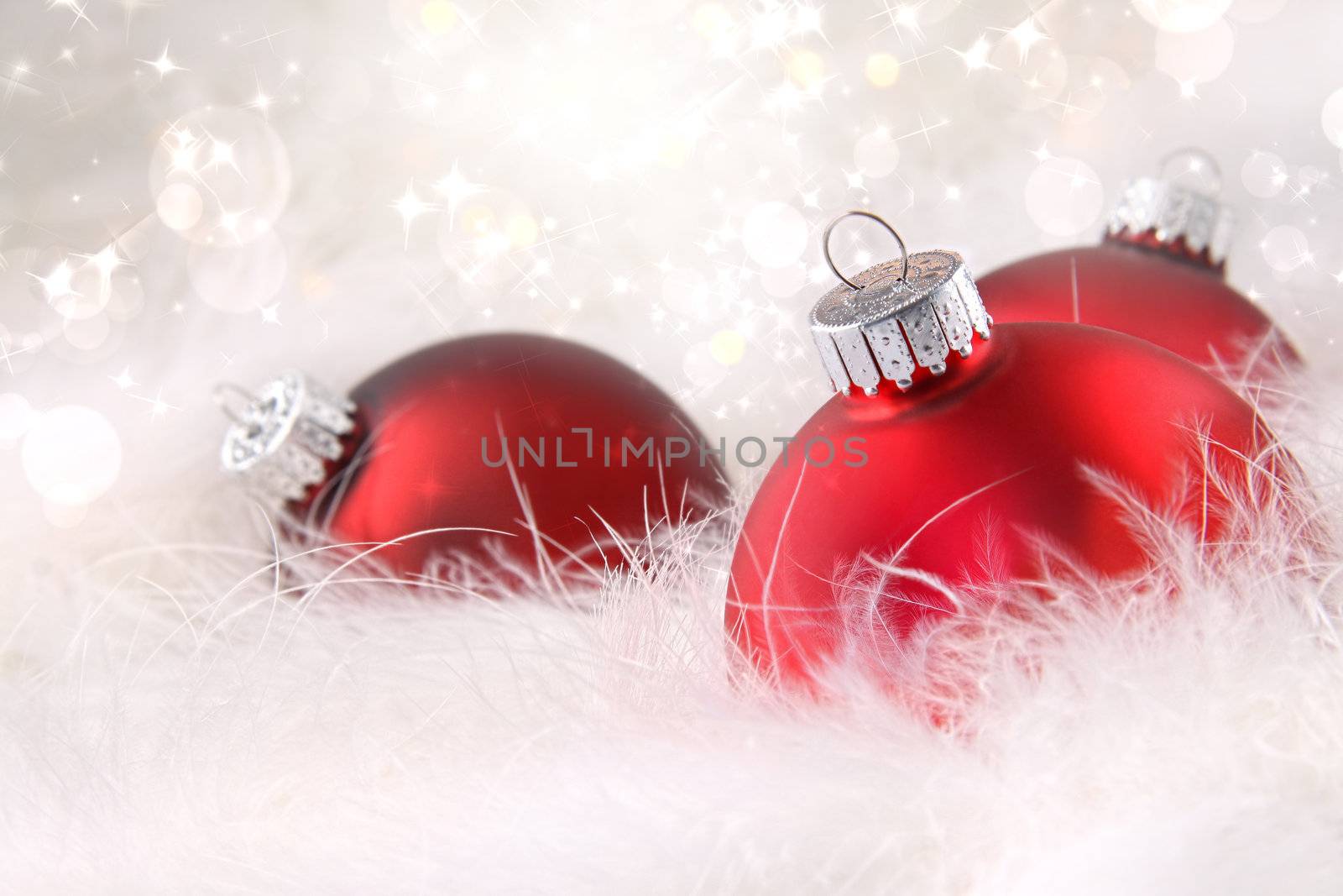 Red Christmas balls in soft white feathers