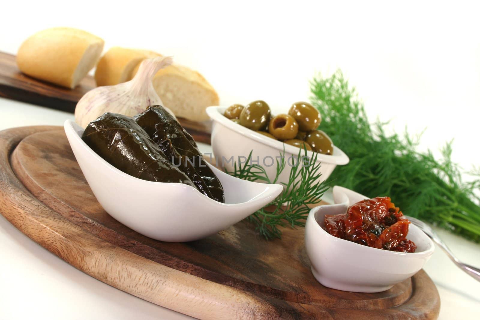 Olives, stuffed vine leaves with rice and pickled dried tomatoes and dill