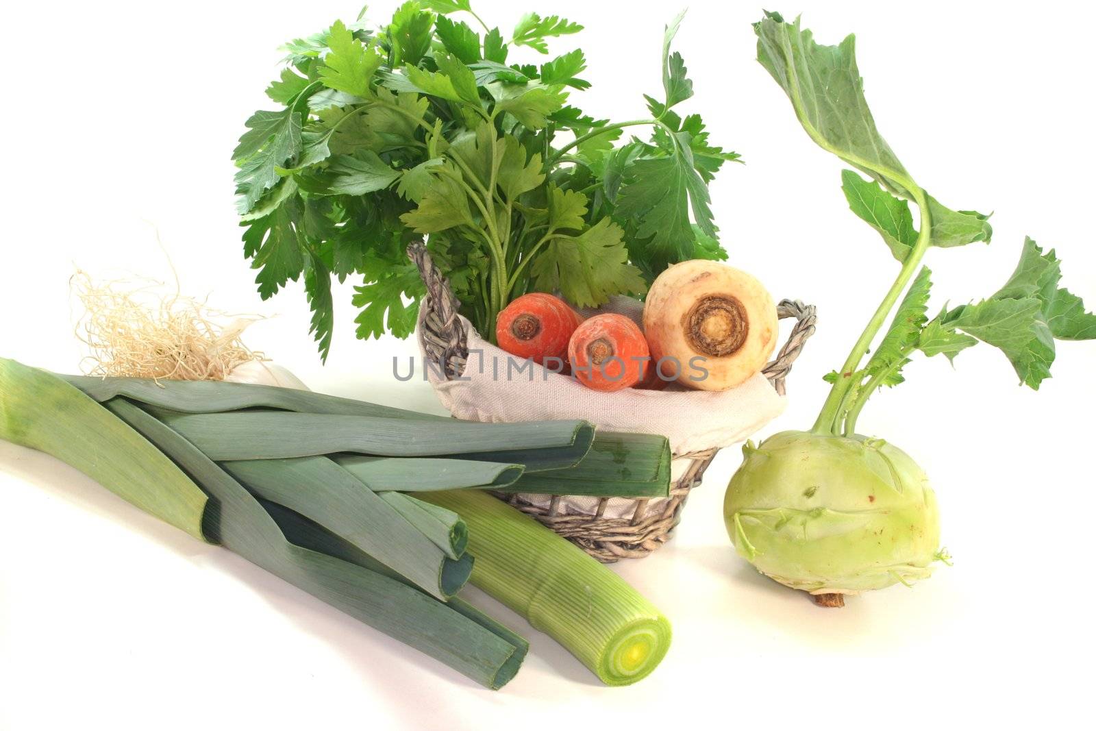 Greens with kohlrabi, carrots, leek, parsley and parsley root in the basket