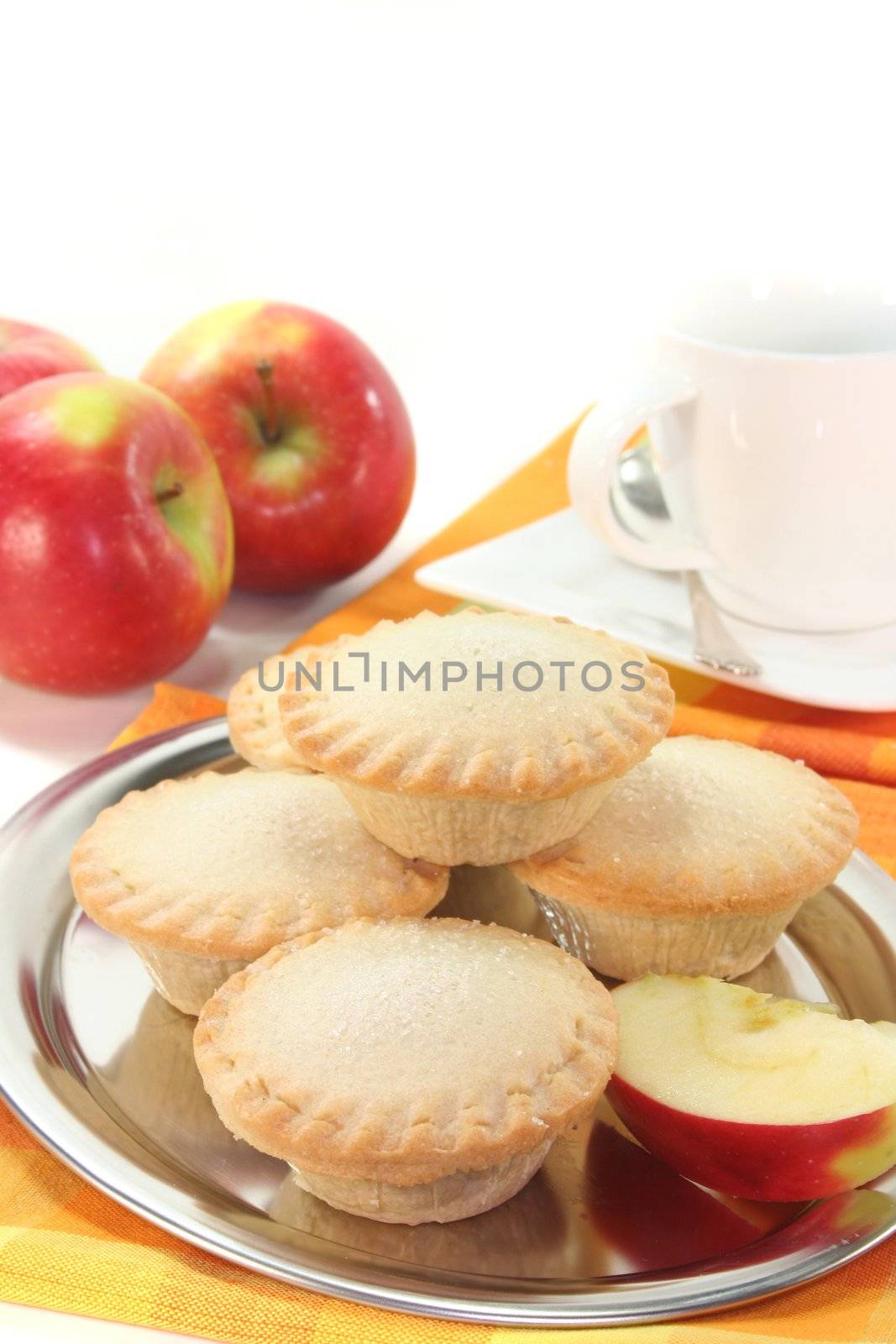 Apple pie on a silver platter in front of white background