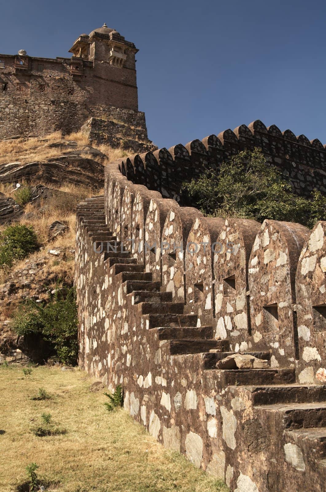 Massive ramparts of Kumbhalgarh Fort with a palace at the top of the hill, Rajasthan, India.