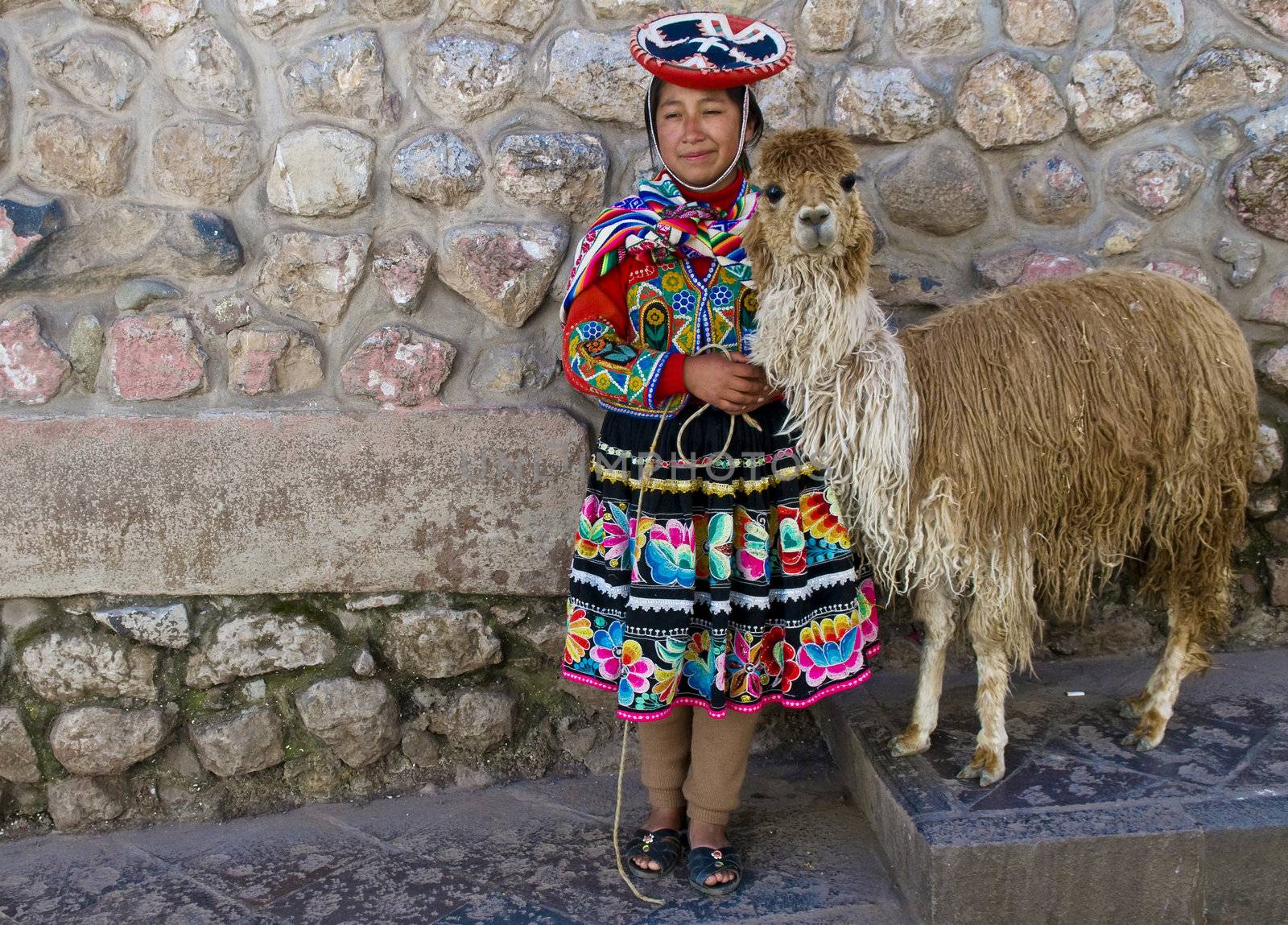 CUSCO , PERU - MAY 27 : Unidentified Peruvian girl in traditional colorful clothes holding alpaca in the street of  the " Unesco world heritage" city "Cusco" on May 27 2011