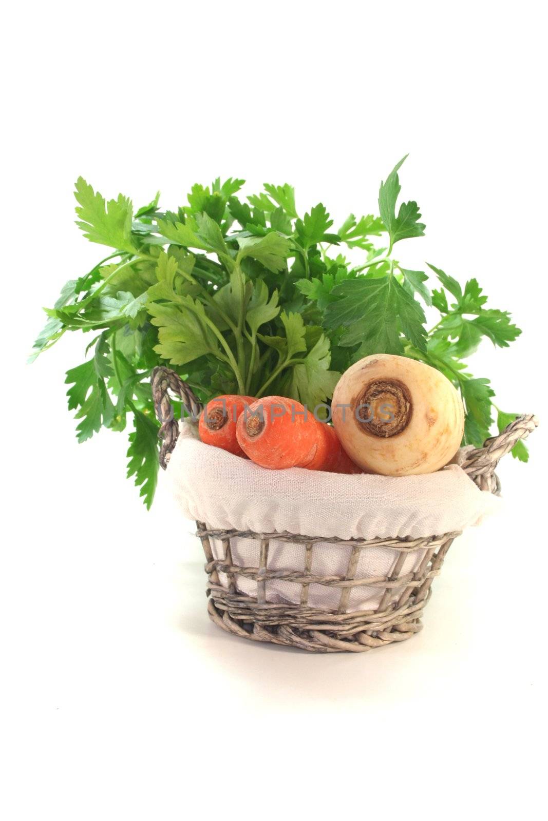 Greens with kohlrabi, carrots, leek, parsley and parsley root in the basket
