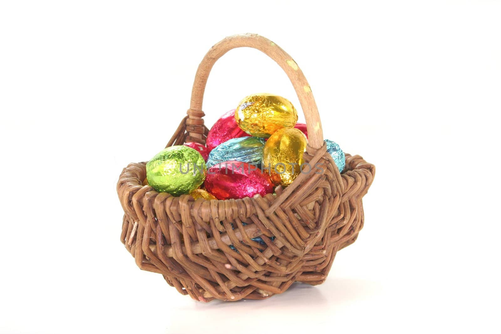 Easter basket with colorful Easter eggs on a white background