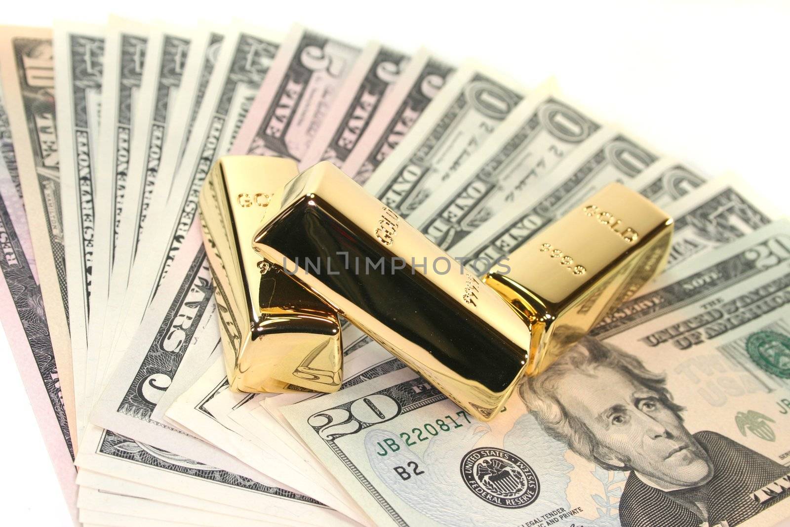 three large gold bars on many dollar bills