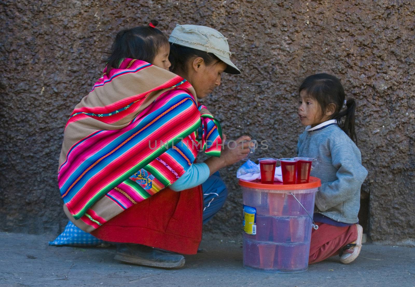 Cusco , Peru - May 28 2011 : Peruvian woman with here children in a market in Cusco Peru