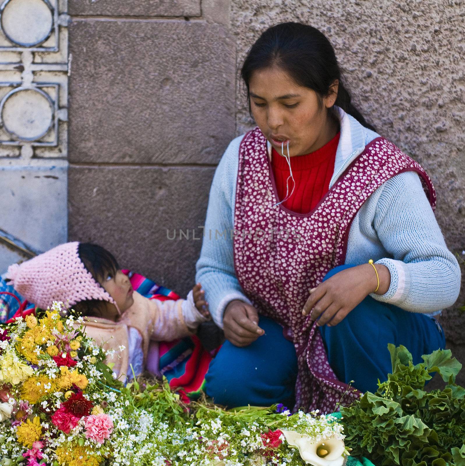 Cusco , Peru - May 28 2011 : Peruvian woman with here child in a market in Cusco Peru