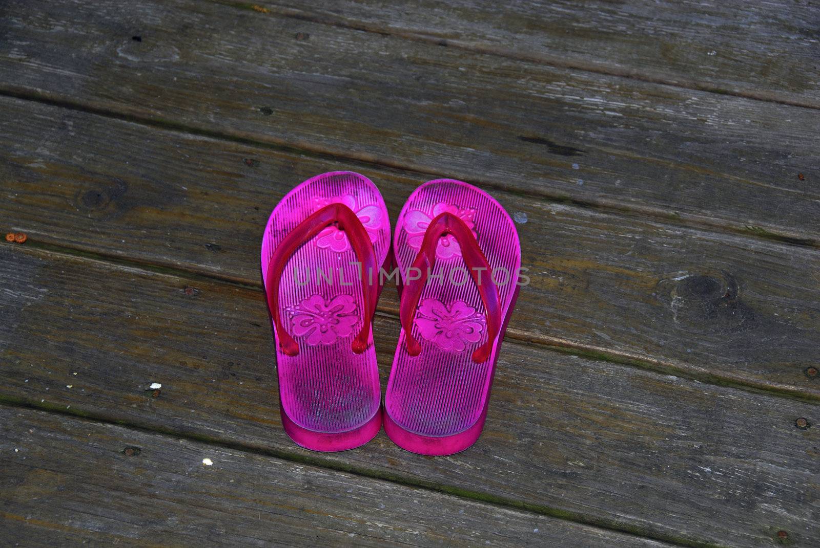 Flip flops isolated on a wooden deck 