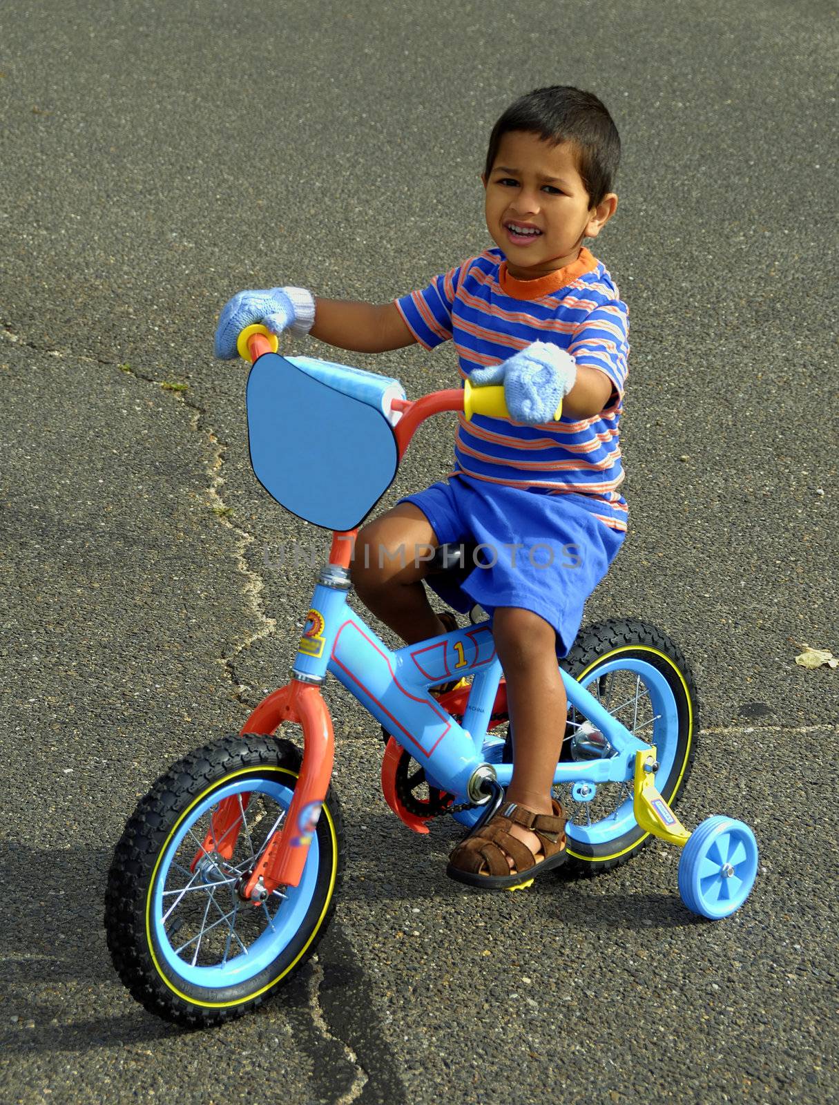 An handsome Indian kid enjoying his bike