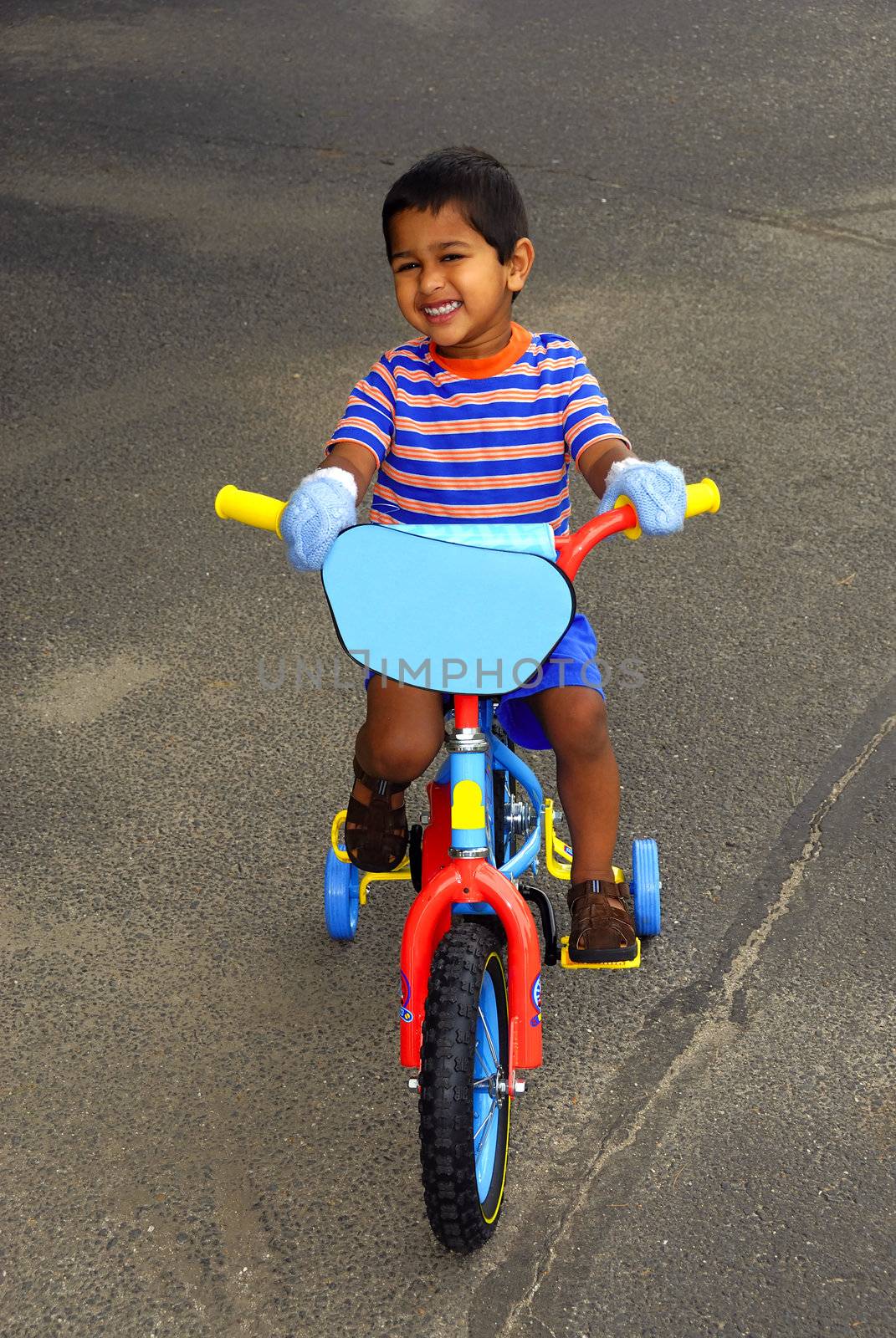 An handsome Indian kid enjoying his bike