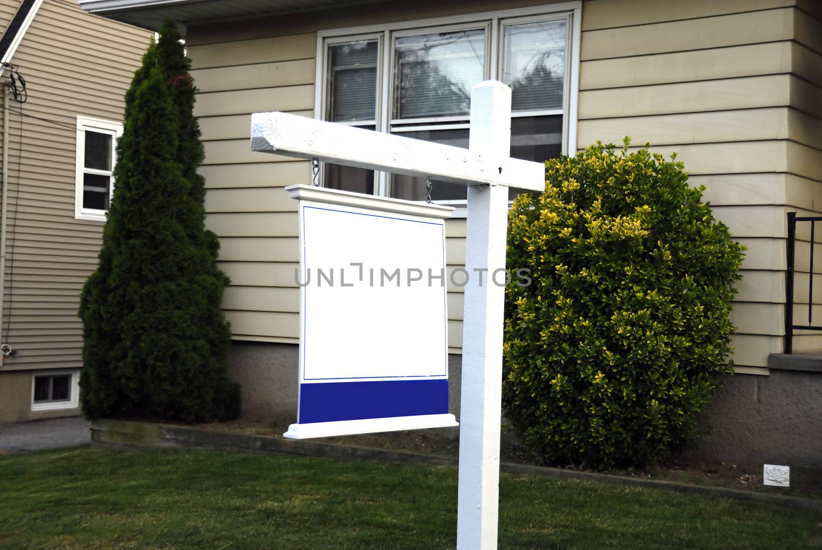 A beautiful house with a signboard for sale