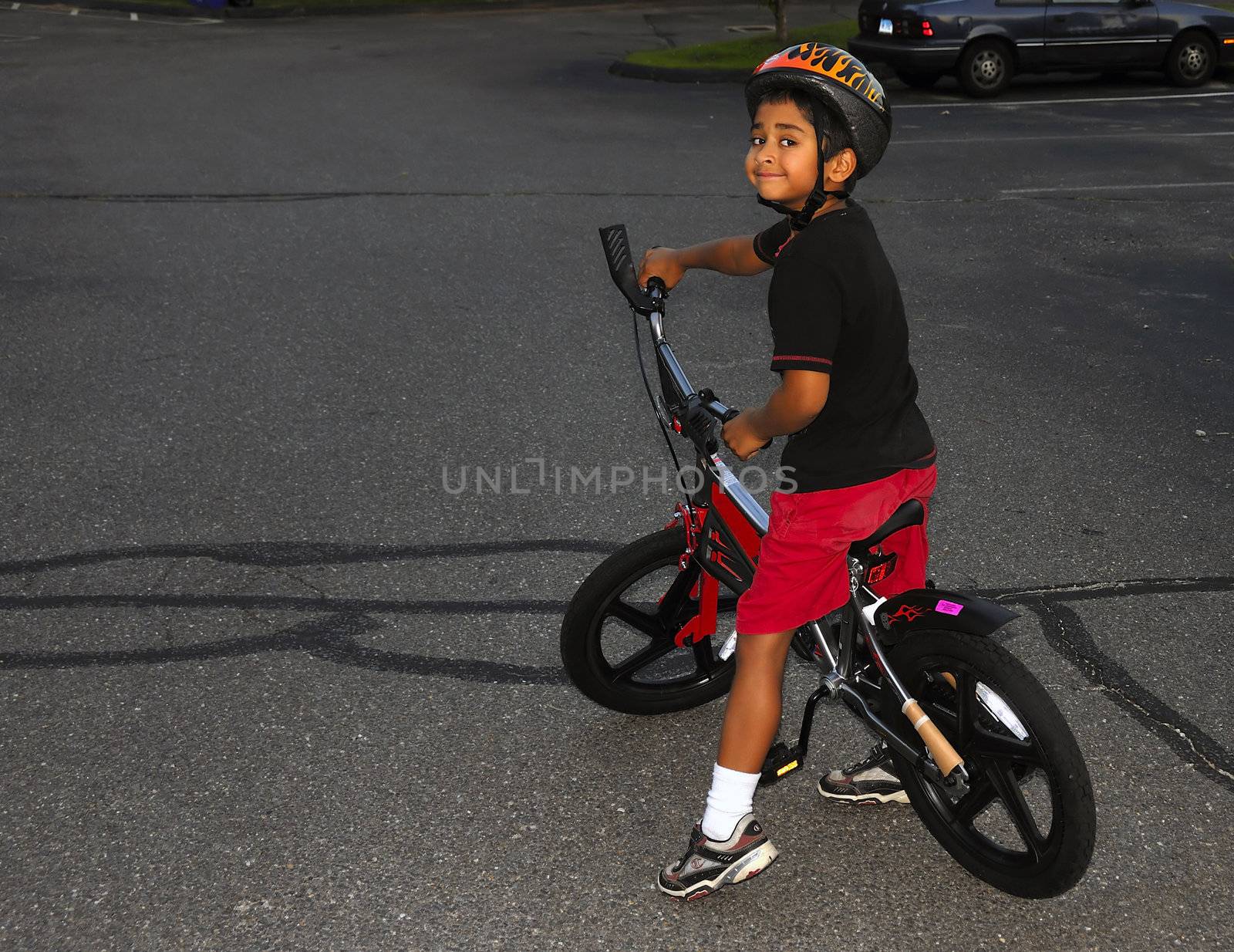An handsome indian kid having fun in bike