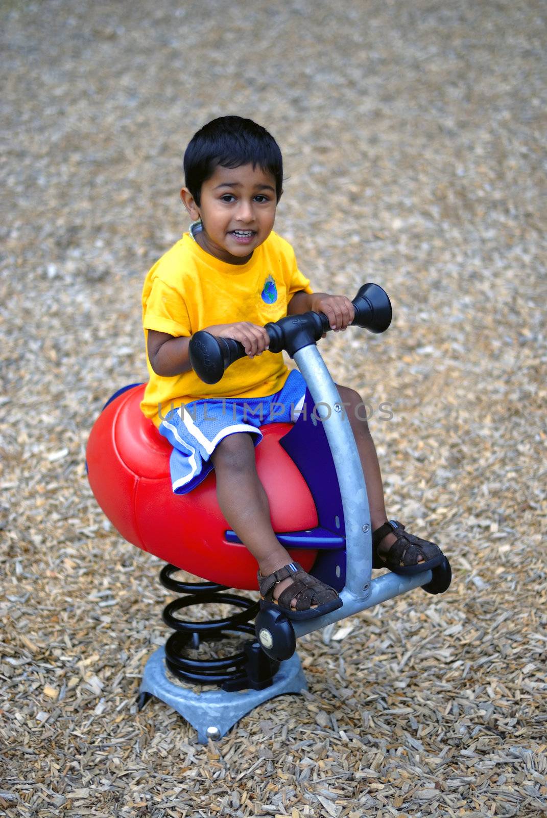 an handsome Indian child happy playing in the play area